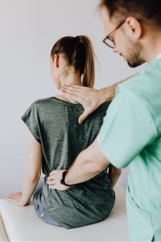 Chiropractor checking a patient's alignment